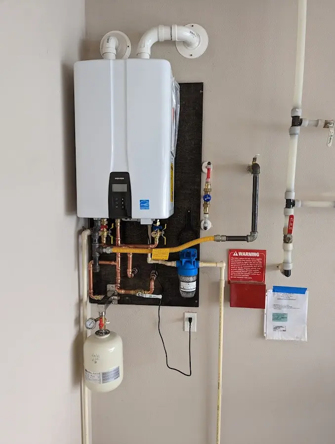 Professional plumber installing copper piping in a St. Louis home